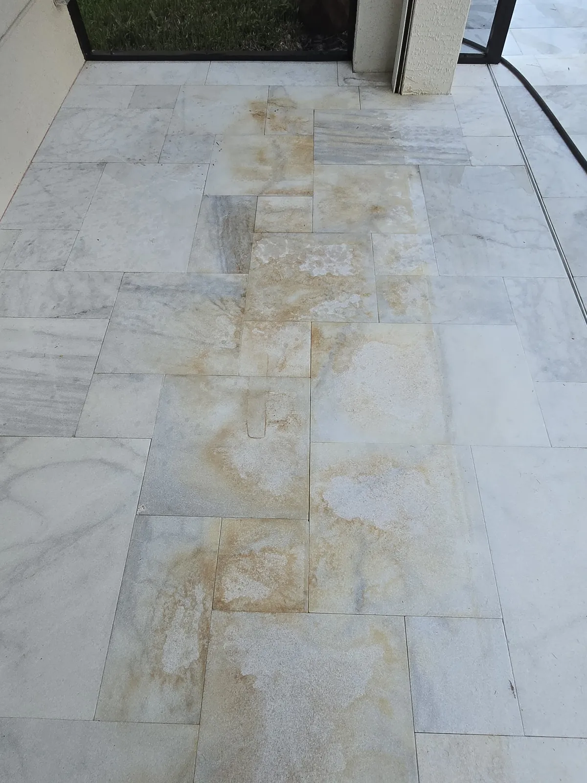 Iron stain pattern on marble near the sliding glass door