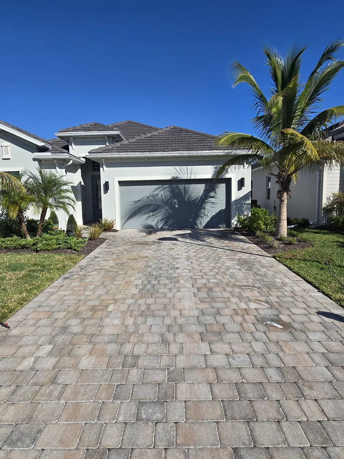 Faded, unsealed paver driveway before the project