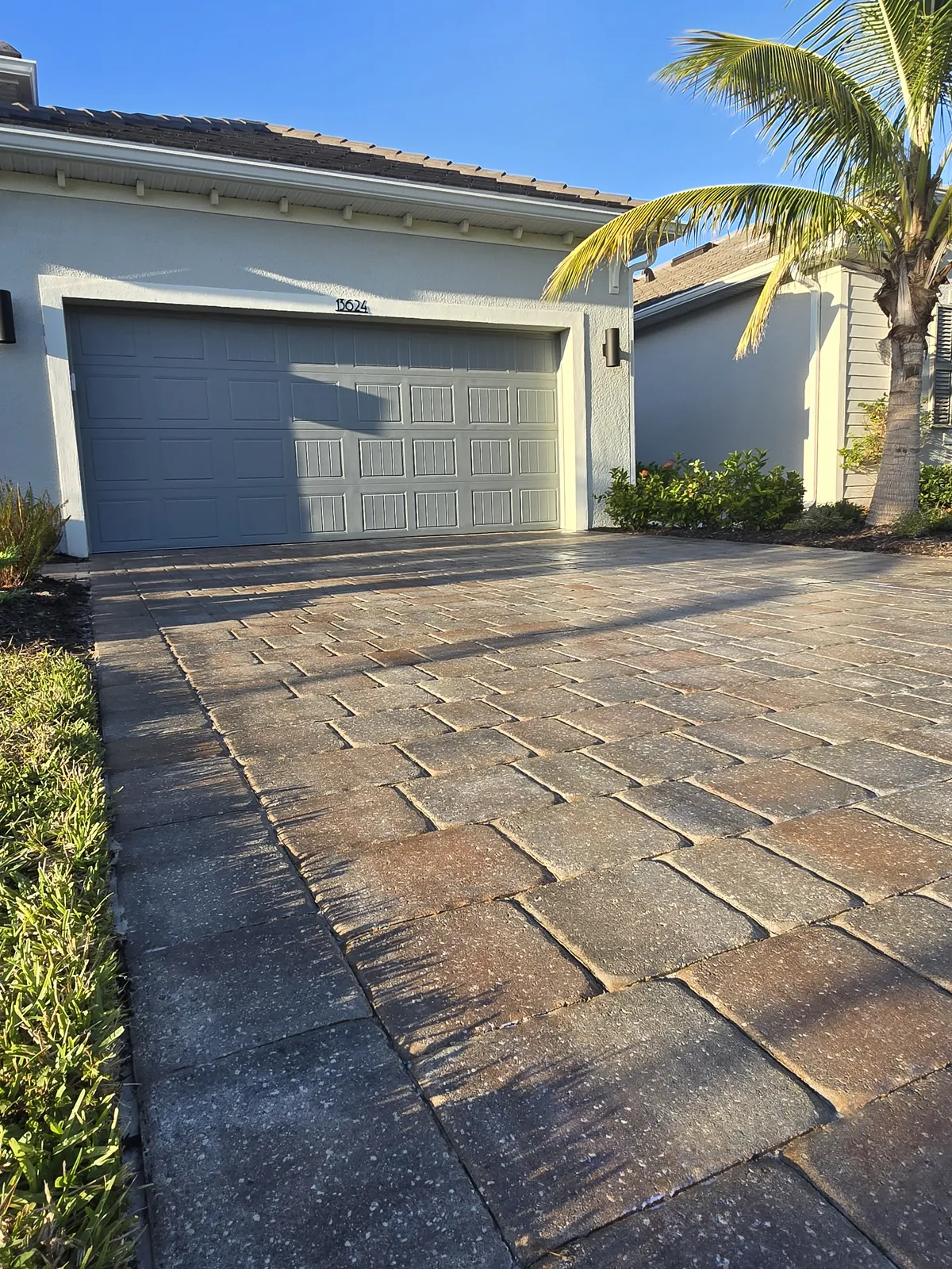 Sealed driveway pavers with deepened color and locked joints
