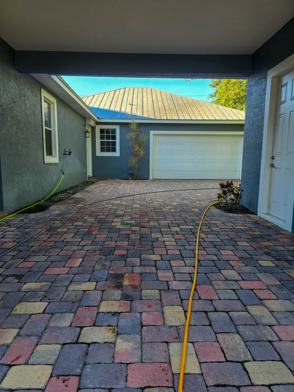 Paver driveway during cleaning, before sealing