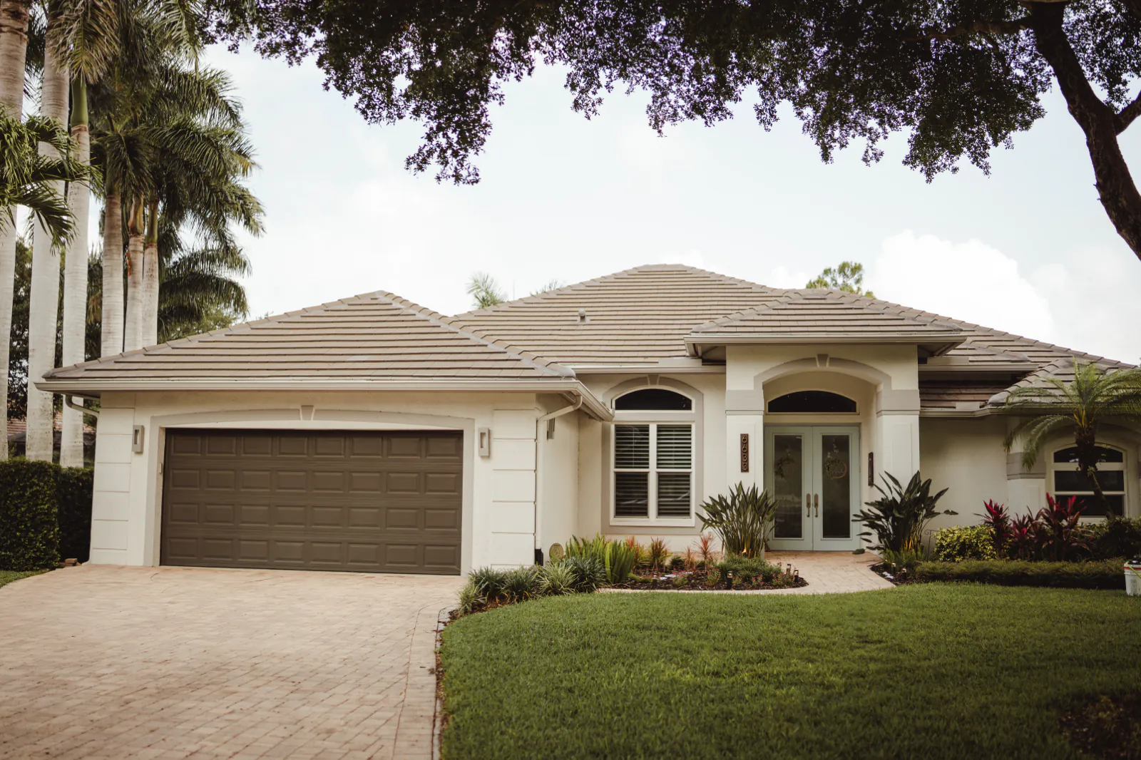Front elevation of the Naples home with its sealed paver driveway
