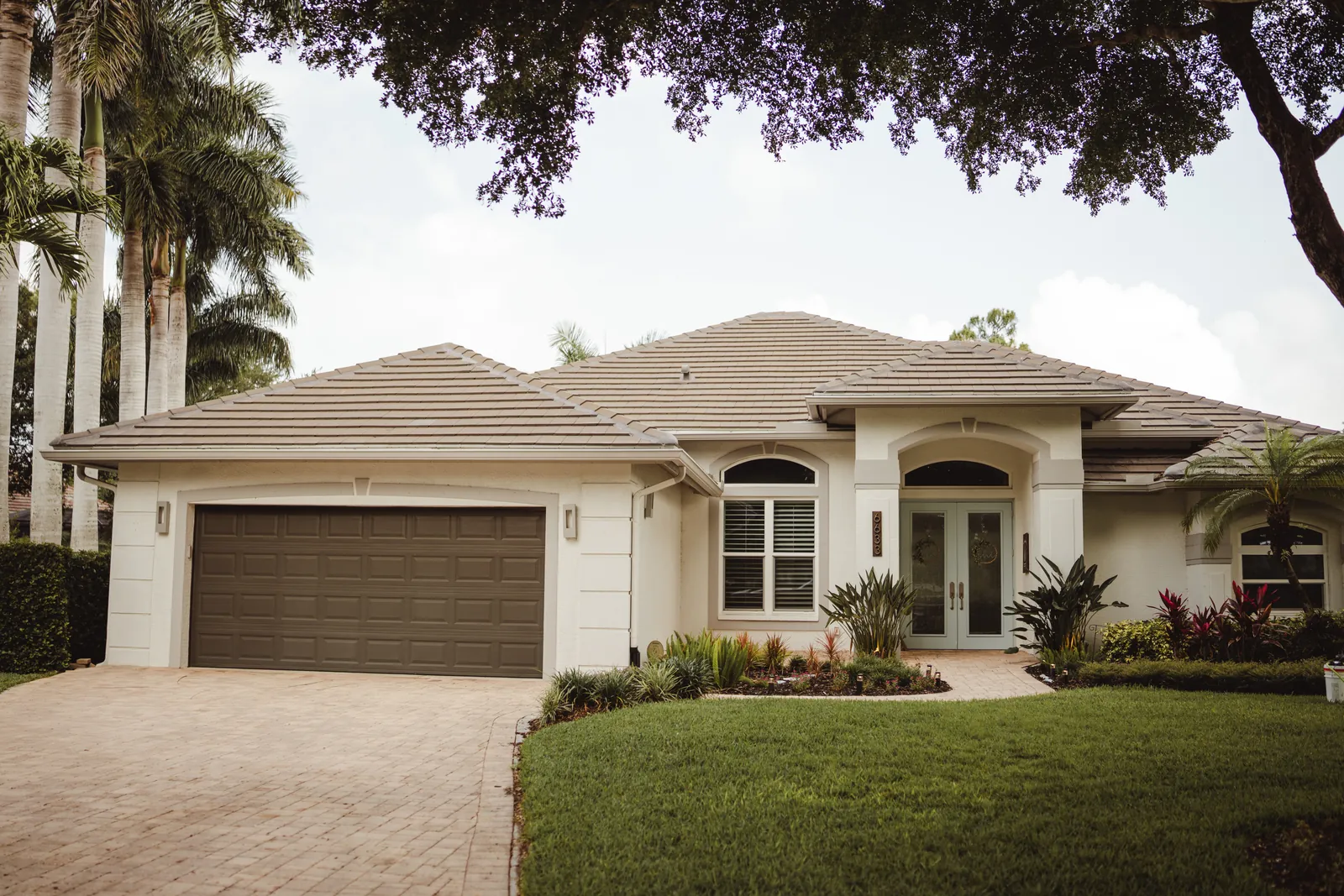 Front elevation of the Naples home with its sealed paver driveway